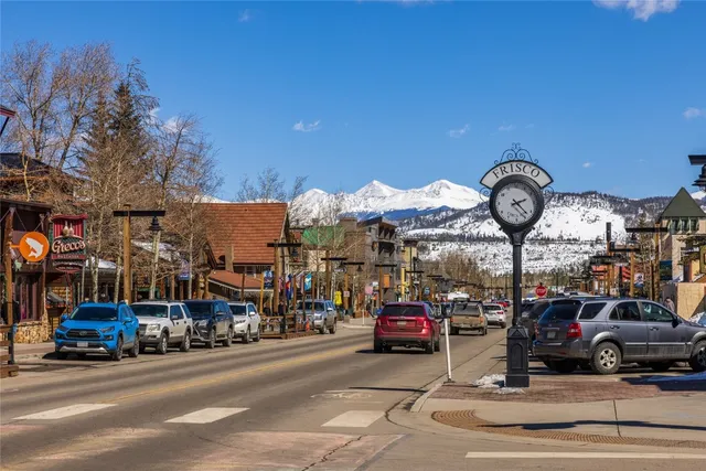 a view of a city street with a car parked on the road