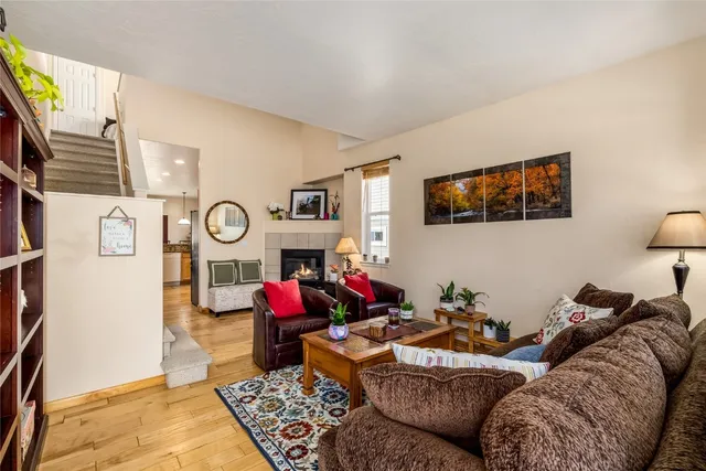 a living room with couch a rug and a window