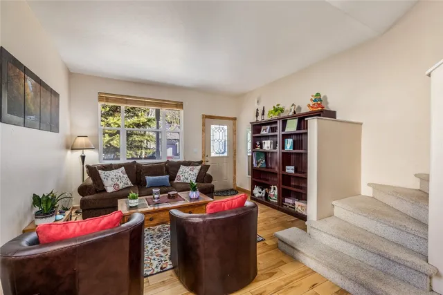 a living room with furniture and a book shelf