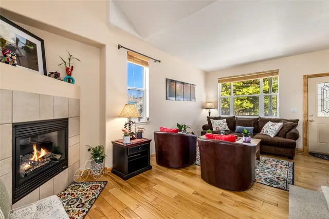 a living room with furniture a fireplace and a window