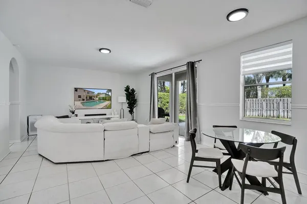 a kitchen with white cabinets and appliances