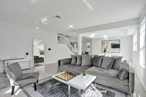 a living room with furniture and a wooden floor