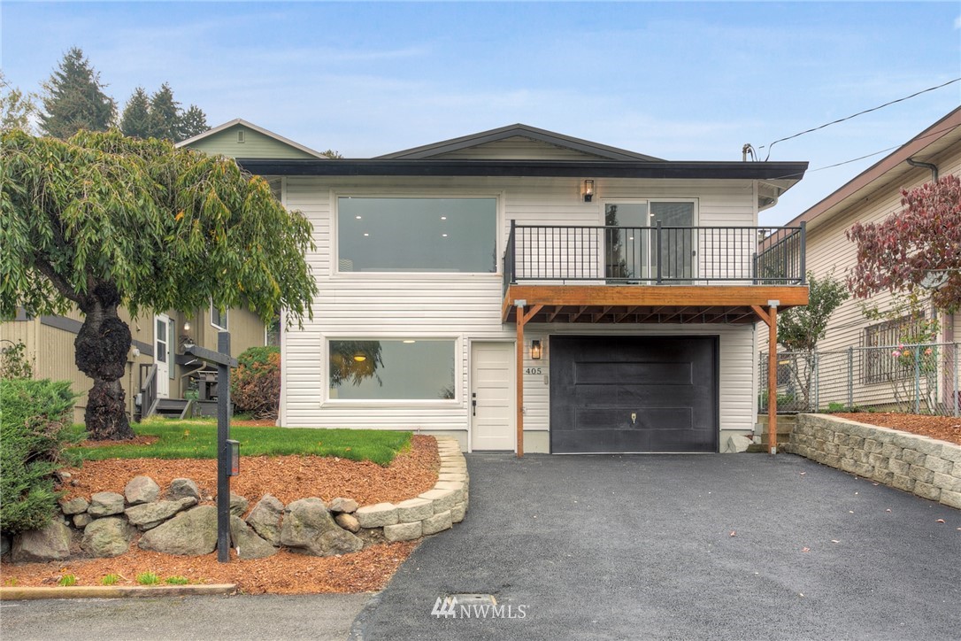405 Maple Avenue Northwest Renton, WA 98057 - Photo 1 of 23 a front view of a house with a yard and garage