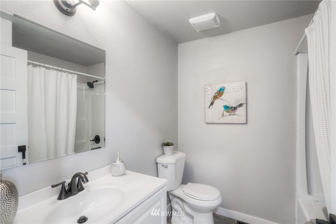 405 Maple Avenue Northwest Renton, WA 98057 - Photo 16 of 23 a bathroom with a sink mirror and toilet