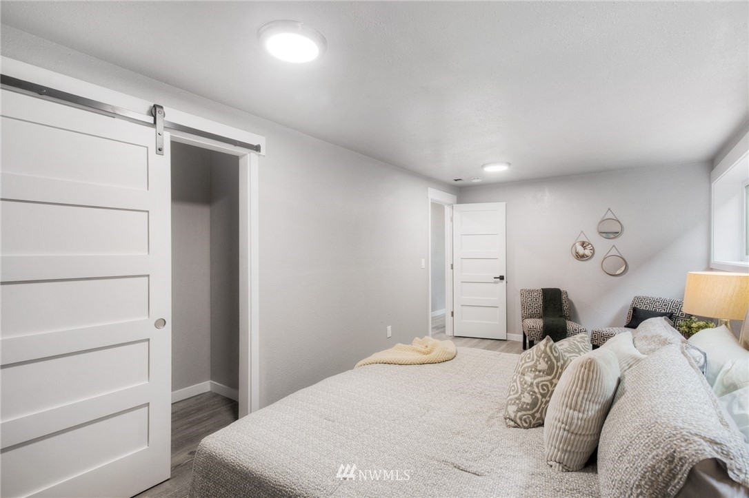405 Maple Avenue Northwest Renton, WA 98057 - Photo 19 of 23 a bedroom with a bed and a window