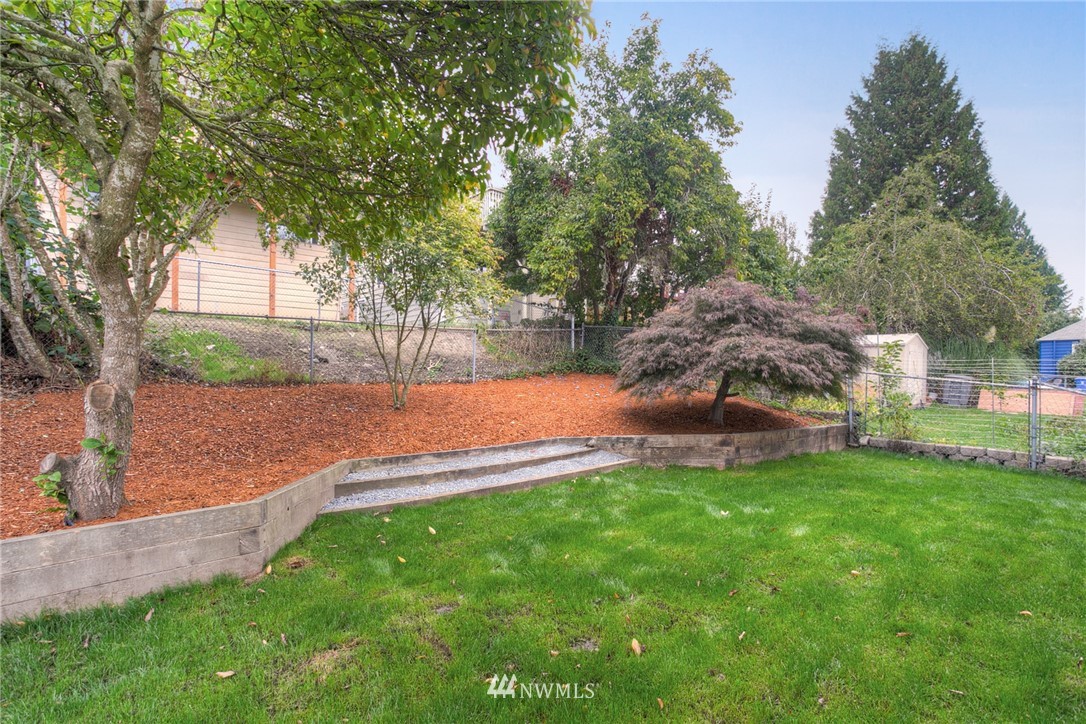 405 Maple Avenue Northwest Renton, WA 98057 - Photo 22 of 23 a view of a backyard with large trees