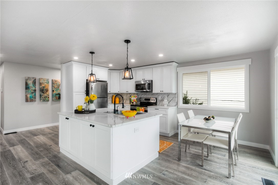 405 Maple Avenue Northwest Renton, WA 98057 - Photo 5 of 23 a living room with stainless steel appliances kitchen island furniture and a window