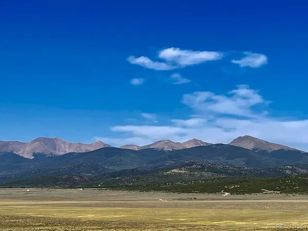 a view of a town with mountains in the background