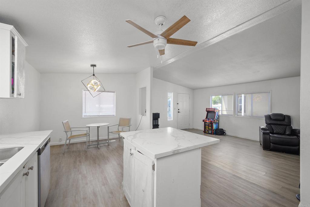 400 Greenfield Drive El Cajon, CA 92021 - Photo 12 of 41 a view of a livingroom with furniture wooden floor a ceiling fan and a window