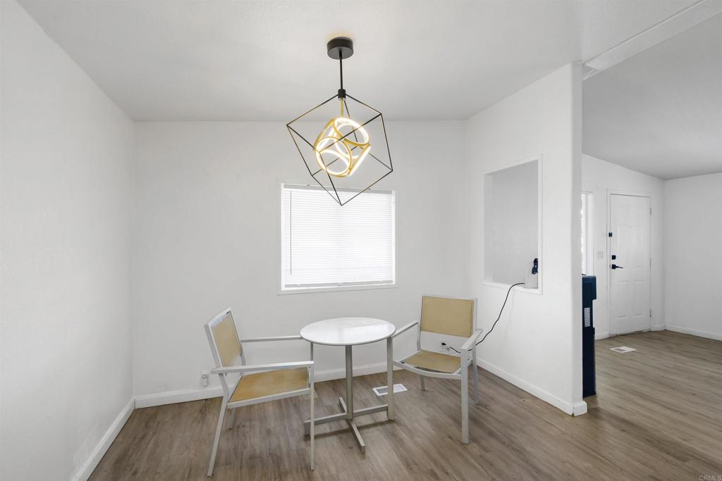 400 Greenfield Drive El Cajon, CA 92021 - Photo 13 of 41 a view of a dining room with furniture a chandelier and wooden floor