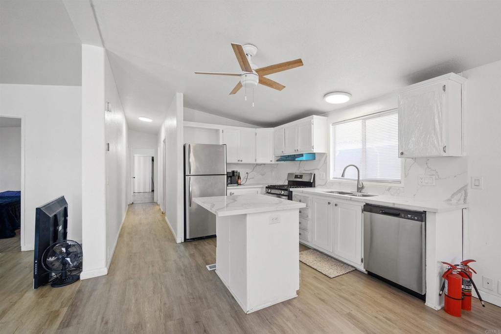 400 Greenfield Drive El Cajon, CA 92021 - Photo 18 of 41 a kitchen with white cabinets and stainless steel appliances