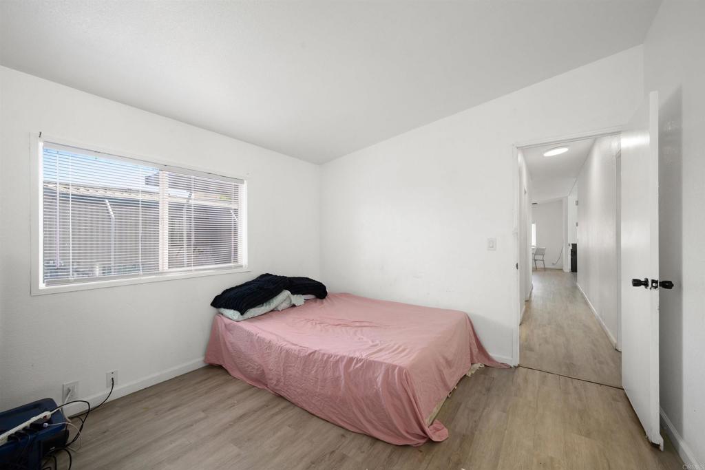 400 Greenfield Drive El Cajon, CA 92021 - Photo 19 of 41 a bedroom with a bed and wooden floor