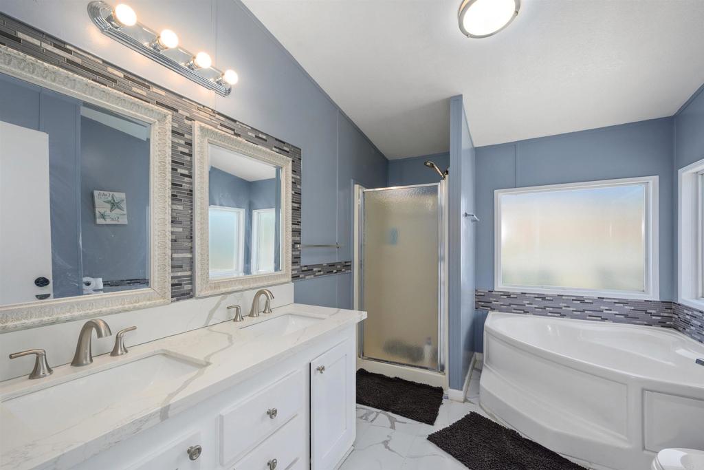 400 Greenfield Drive El Cajon, CA 92021 - Photo 21 of 41 a bathroom with a granite countertop sink and a mirror