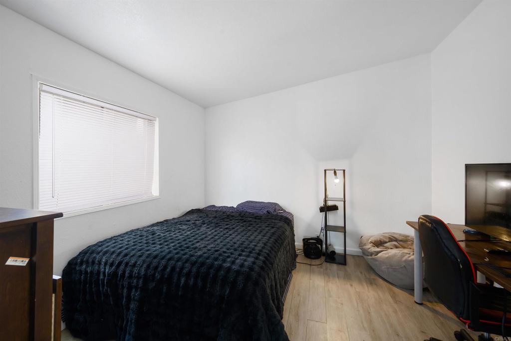 400 Greenfield Drive El Cajon, CA 92021 - Photo 24 of 41 a bedroom with a bed and a chair