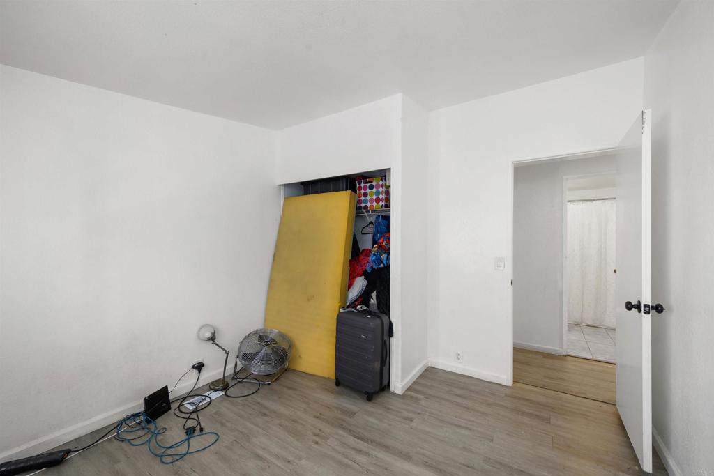 400 Greenfield Drive El Cajon, CA 92021 - Photo 27 of 41 an empty room with wooden floor and closet
