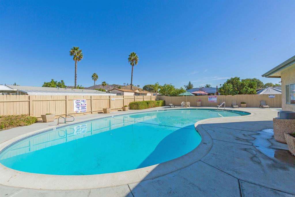 400 Greenfield Drive El Cajon, CA 92021 - Photo 35 of 41 a view of a swimming pool with a lawn chairs under an umbrella