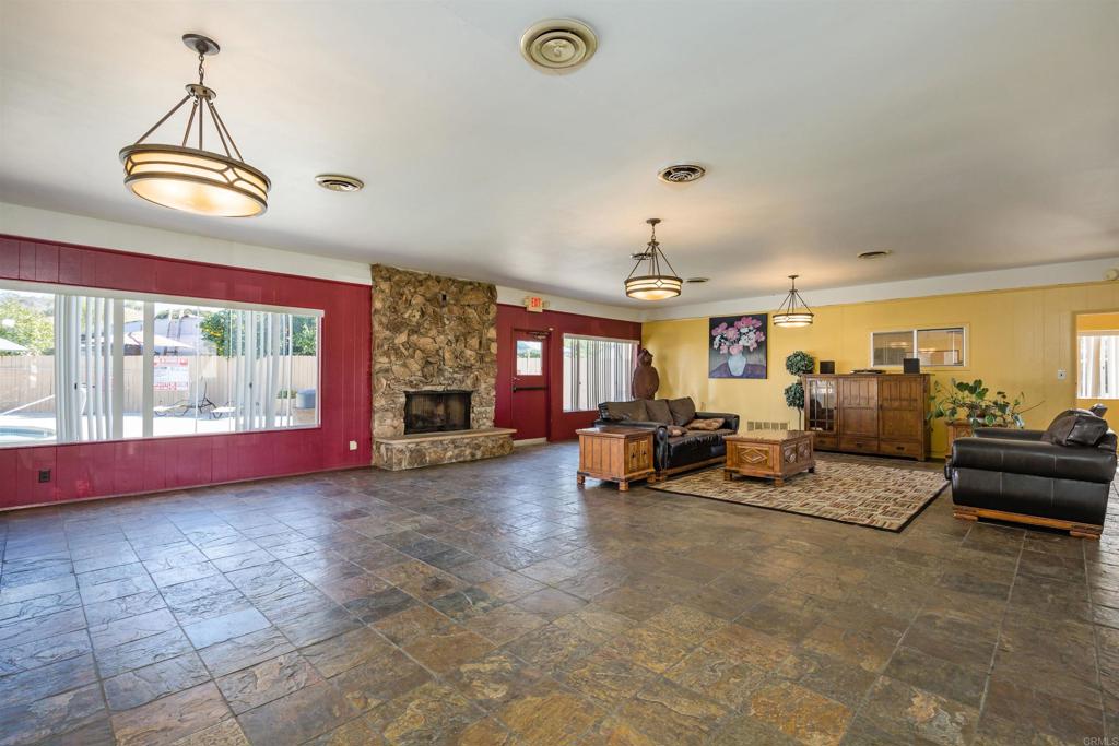 400 Greenfield Drive El Cajon, CA 92021 - Photo 38 of 41 a view of a livingroom with furniture a fireplace and window
