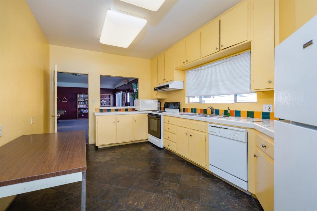 400 Greenfield Drive El Cajon, CA 92021 - Photo 40 of 41 a kitchen with stainless steel appliances granite countertop a refrigerator and a stove top oven