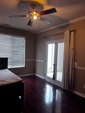 a view of a livingroom with hardwood floor and a ceiling fan