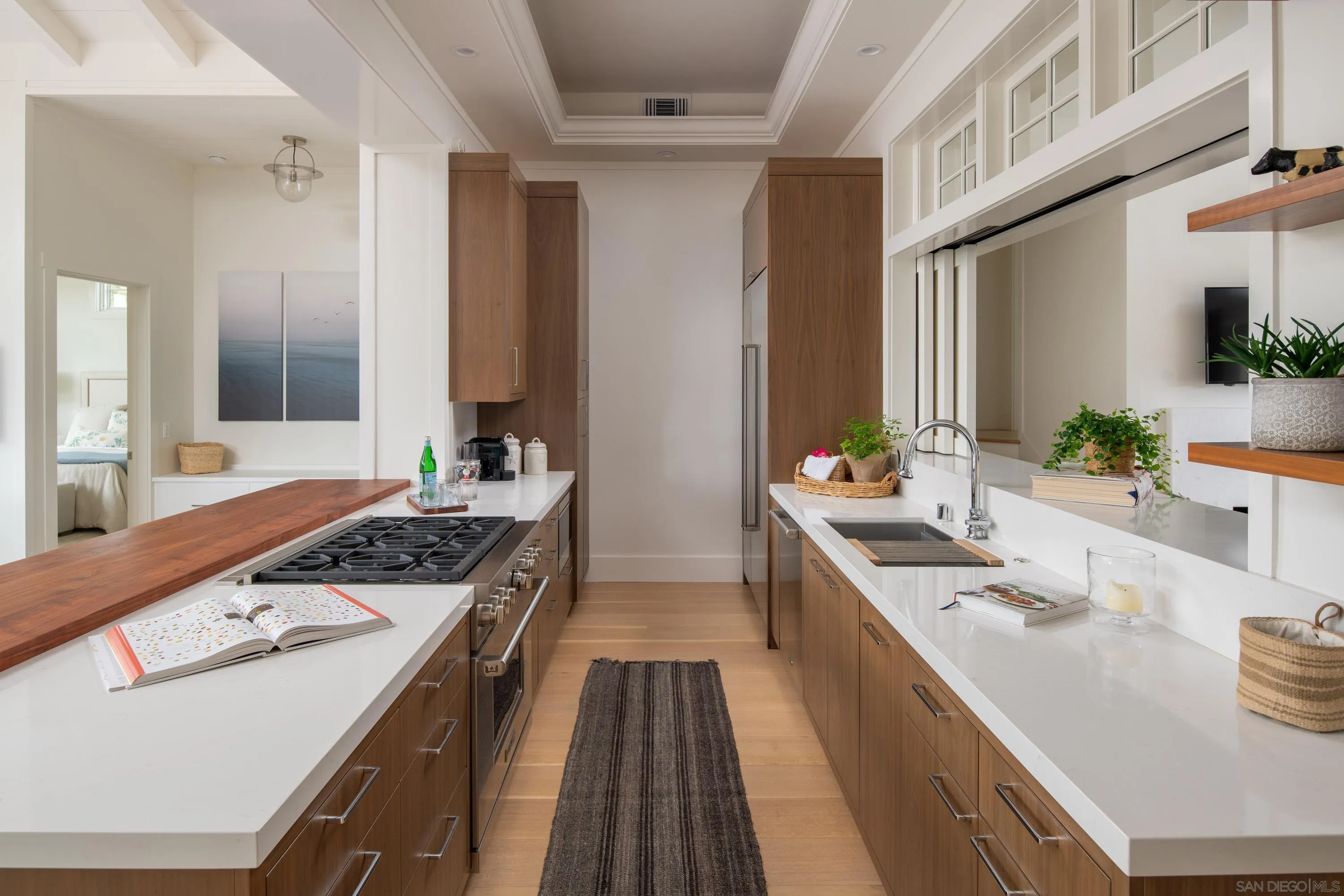 236 24th Street Del Mar, CA 92014 - Photo 13 of 34 a kitchen with a sink stove and wooden cabinets