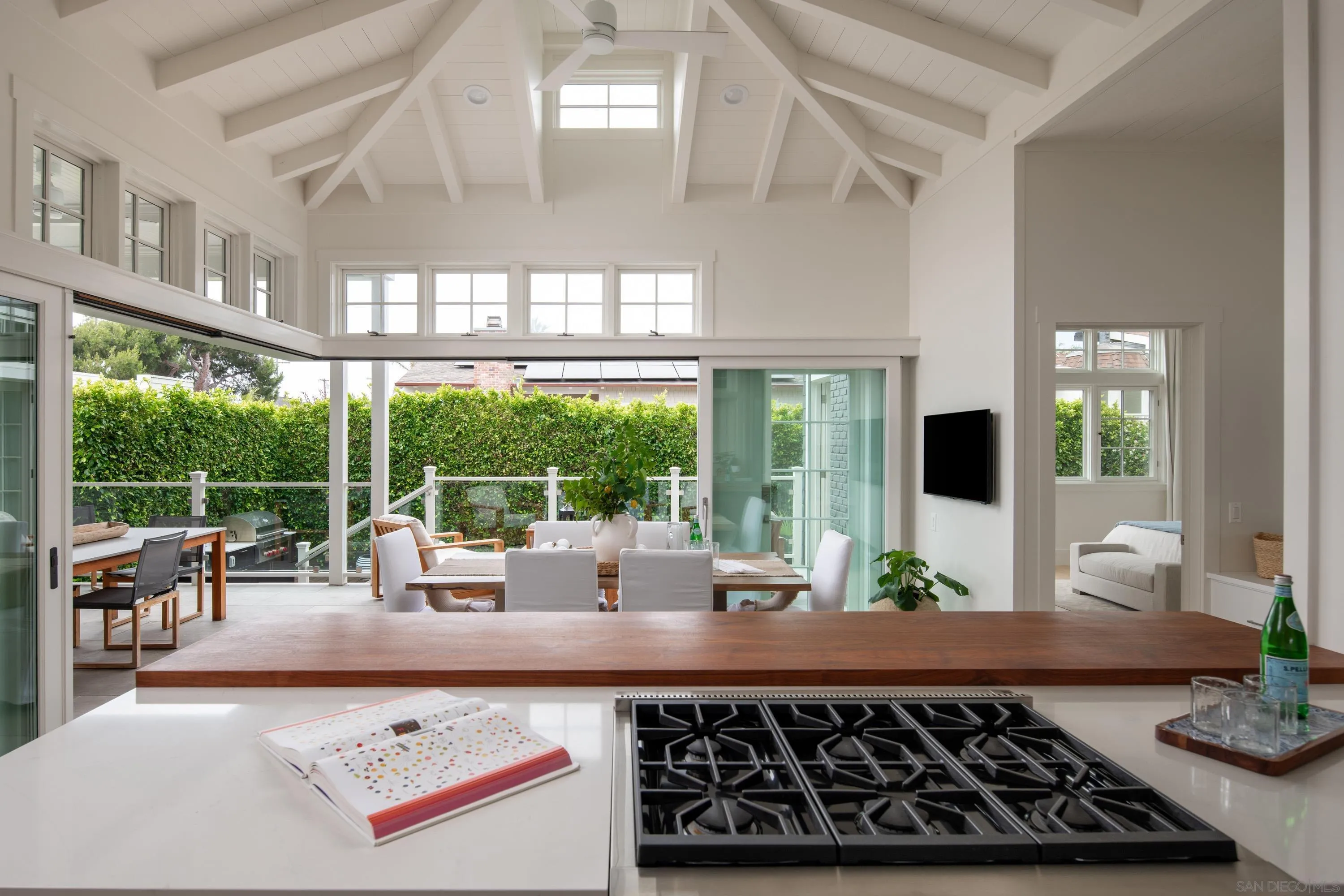 236 24th Street Del Mar, CA 92014 - Photo 8 of 34 a kitchen with stainless steel appliances a stove and white cabinets with wooden floor