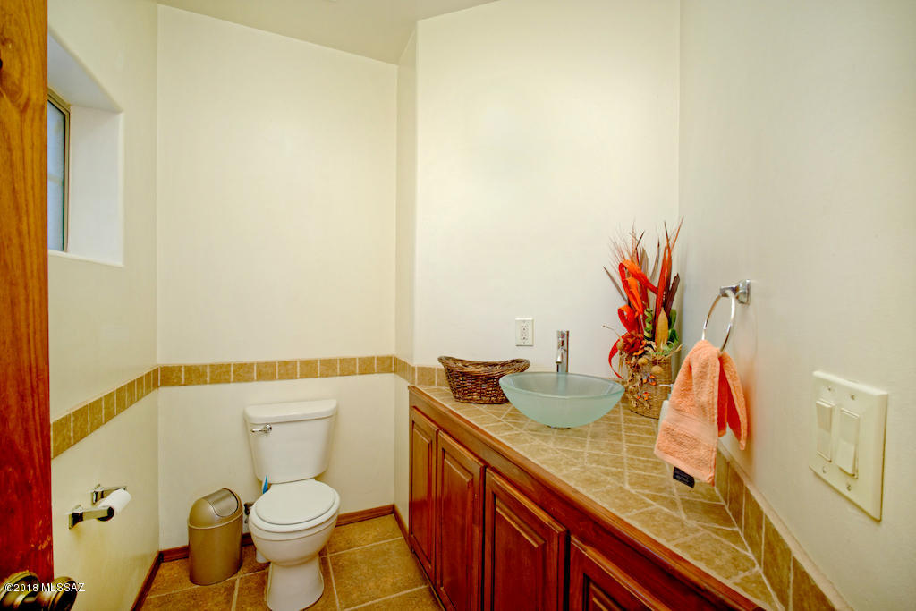 1721 Camino Jalisco Rio Rico, AZ 85648 - Photo 9 of 39 a bathroom with a granite countertop sink and a mirror