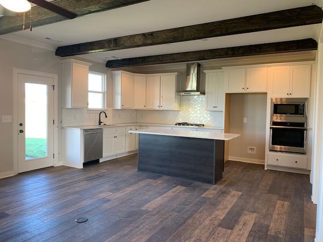 762 Plowson Road, Unit 363 Mount Juliet, TN 37122 - Photo 4 of 22 Large quartz kitchen island with built in oven and cooktop! Perfect for holiday meals