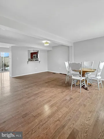 a living room with a wooden floor and furniture