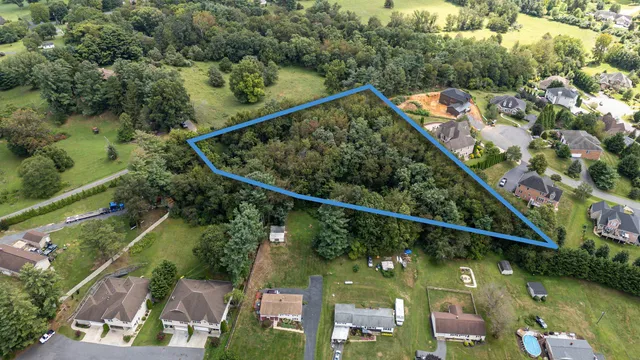 an aerial view of residential houses with outdoor space and swimming pool