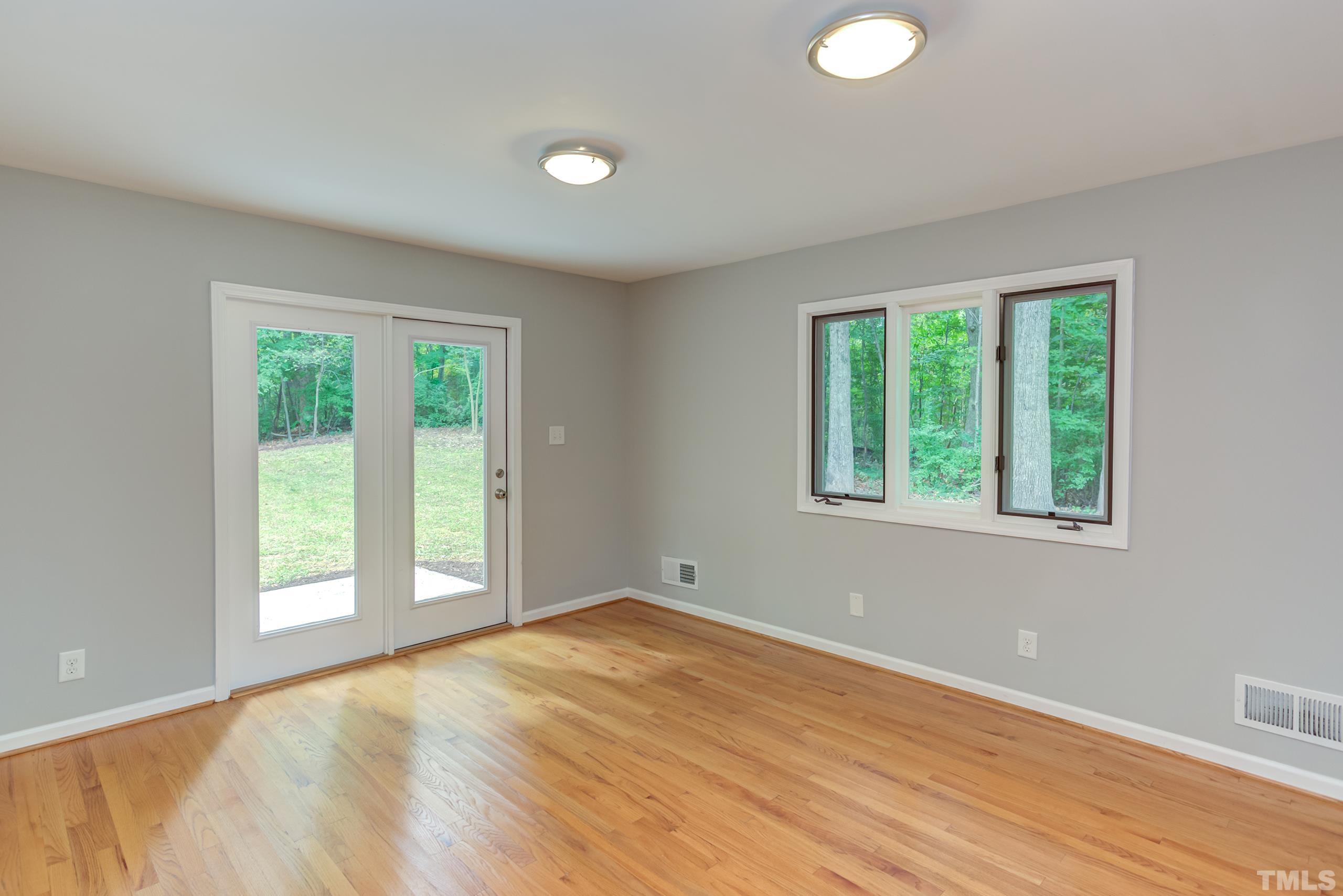 912 Winona Road Raleigh, NC 27609 - Photo 12 of 30 a view of an empty room with wooden floor and a window
