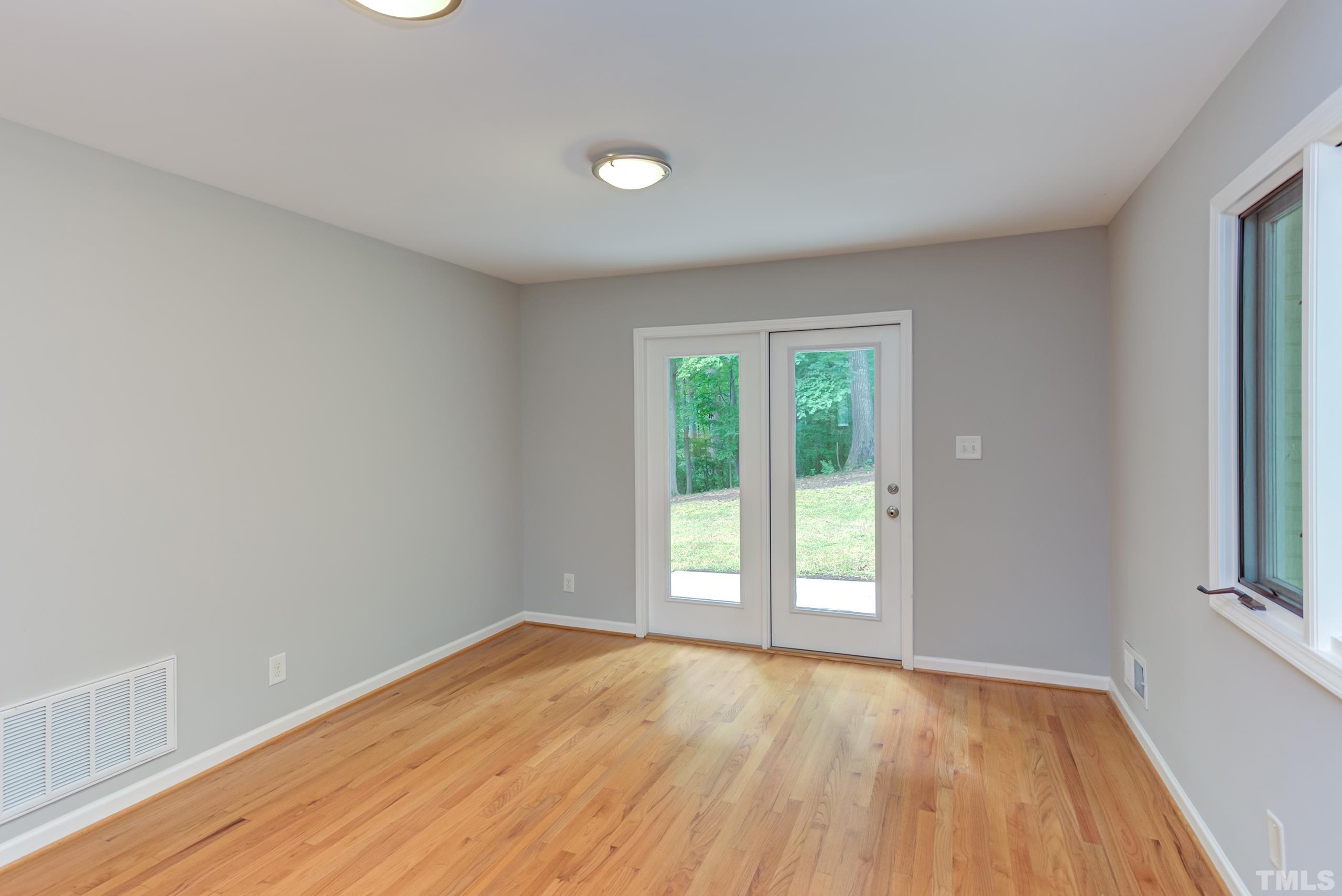 912 Winona Road Raleigh, NC 27609 - Photo 13 of 30 an empty room with wooden floor and windows