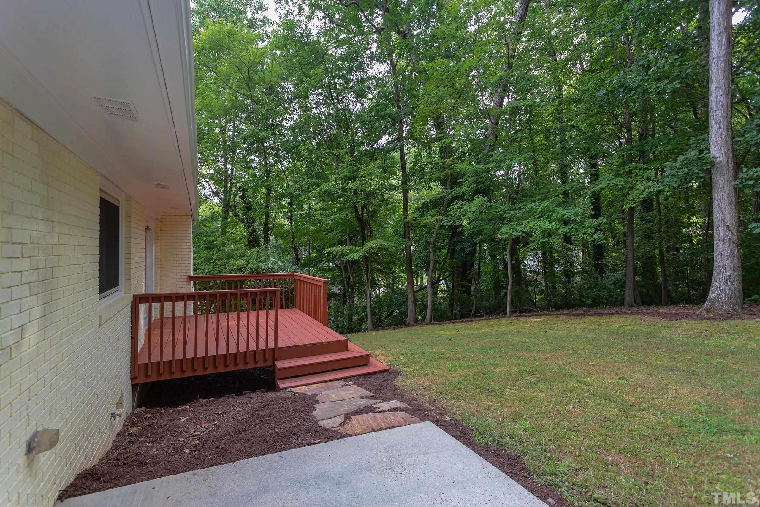 912 Winona Road Raleigh, NC 27609 - Photo 27 of 30 a view of backyard with wooden fence and trees