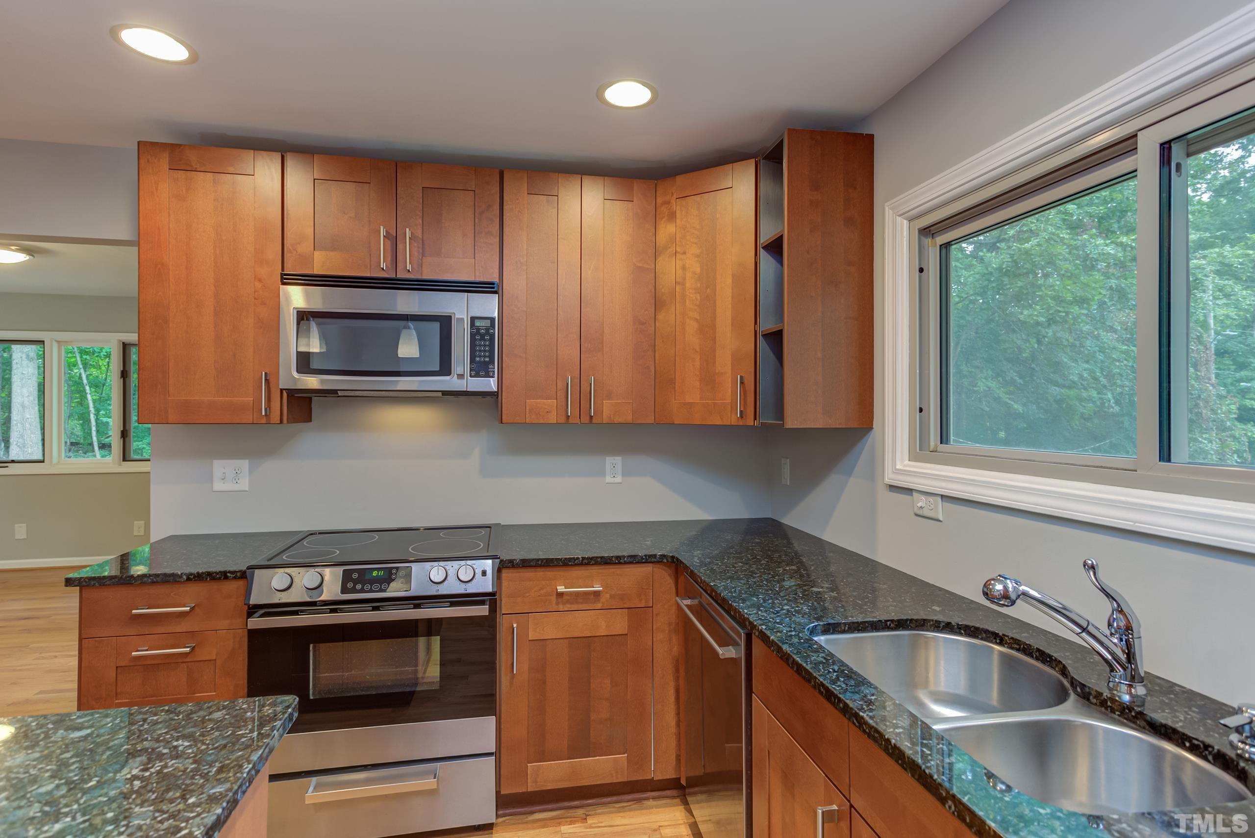 912 Winona Road Raleigh, NC 27609 - Photo 4 of 30 a kitchen with granite countertop a sink stainless steel appliances and cabinets