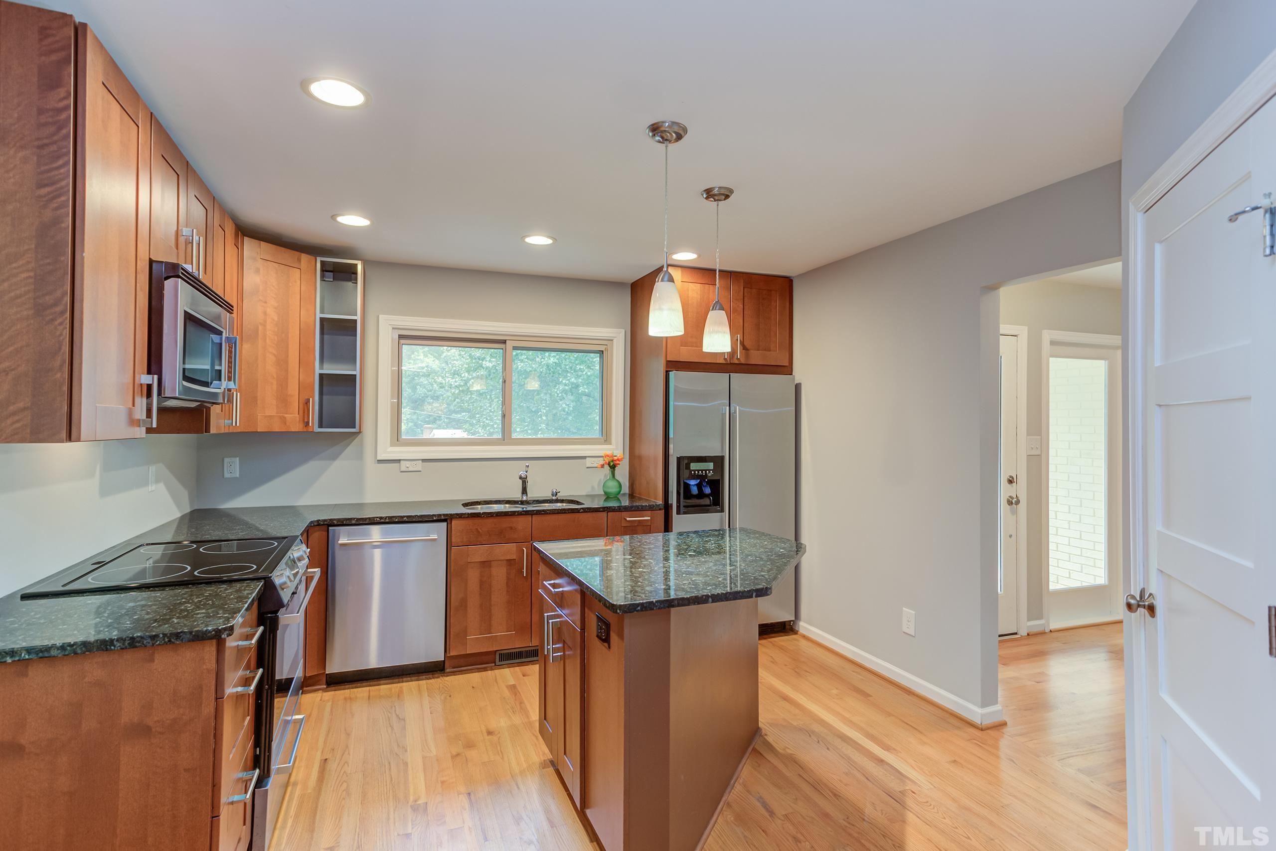 912 Winona Road Raleigh, NC 27609 - Photo 5 of 30 a kitchen with stainless steel appliances granite countertop sink stove refrigerator and cabinets