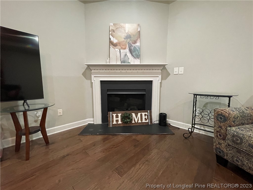 6298 Phillipi Church Road Raeford, NC 28376 - Photo 13 of 31 a living room with furniture a fireplace and a flat screen tv