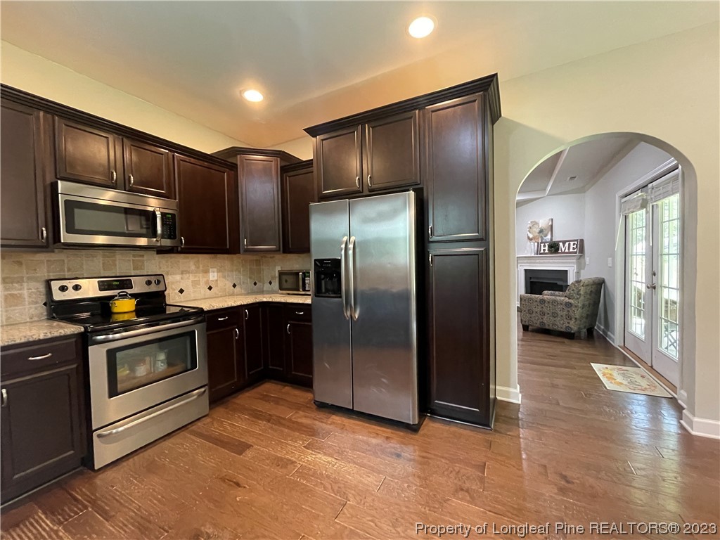 6298 Phillipi Church Road Raeford, NC 28376 - Photo 15 of 31 a kitchen with granite countertop stainless steel appliances and wooden cabinets