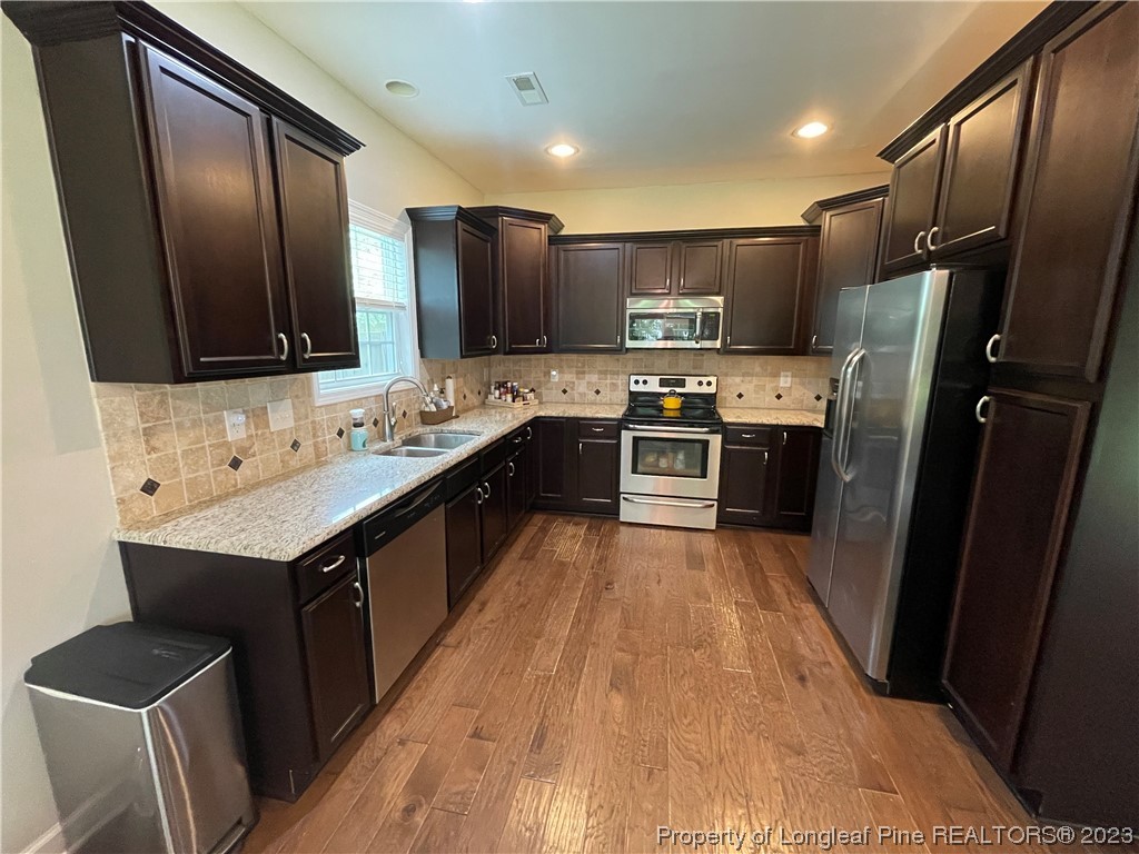 6298 Phillipi Church Road Raeford, NC 28376 - Photo 16 of 31 a kitchen with stainless steel appliances granite countertop a stove a sink dishwasher a refrigerator and a oven