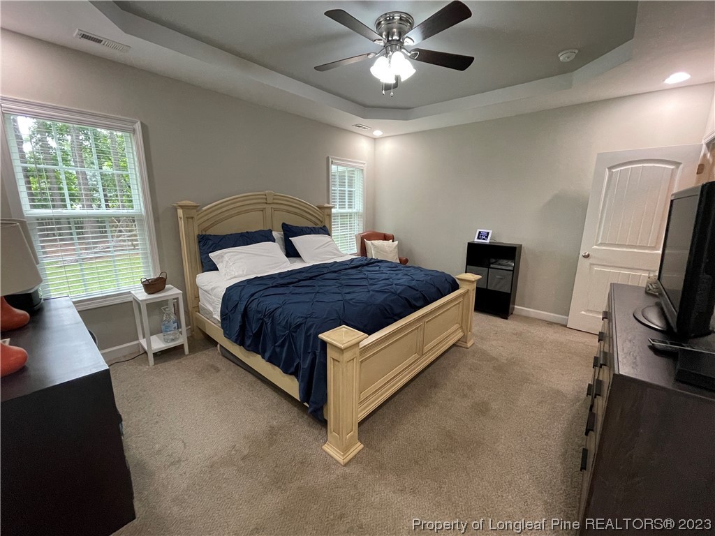 6298 Phillipi Church Road Raeford, NC 28376 - Photo 20 of 31 a bedroom with a bed lamp on desk and a window
