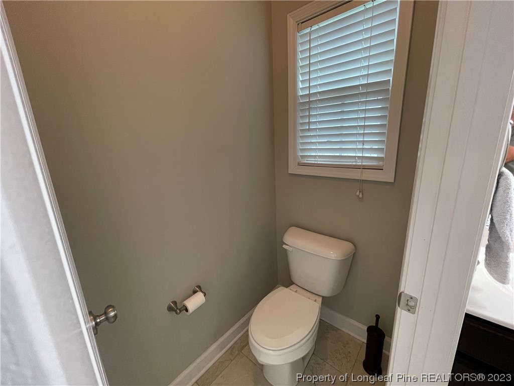 6298 Phillipi Church Road Raeford, NC 28376 - Photo 22 of 31 a white toilet sitting next to a small bathroom