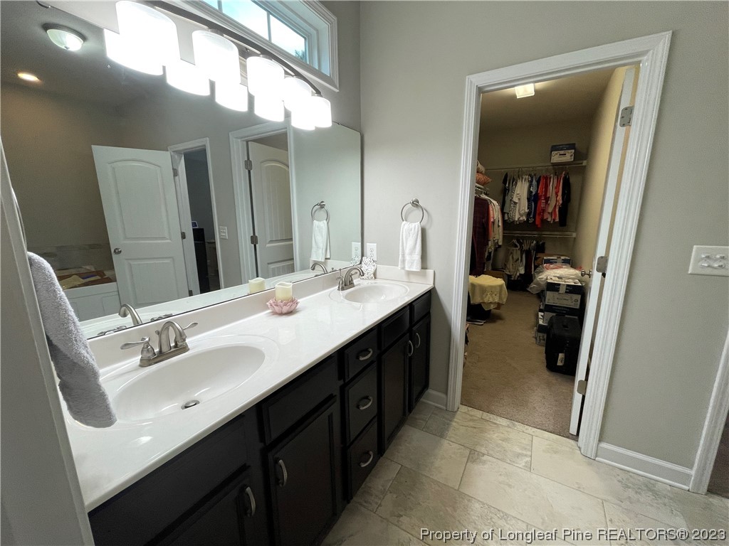 6298 Phillipi Church Road Raeford, NC 28376 - Photo 23 of 31 a bathroom with a double vanity sink and a mirror