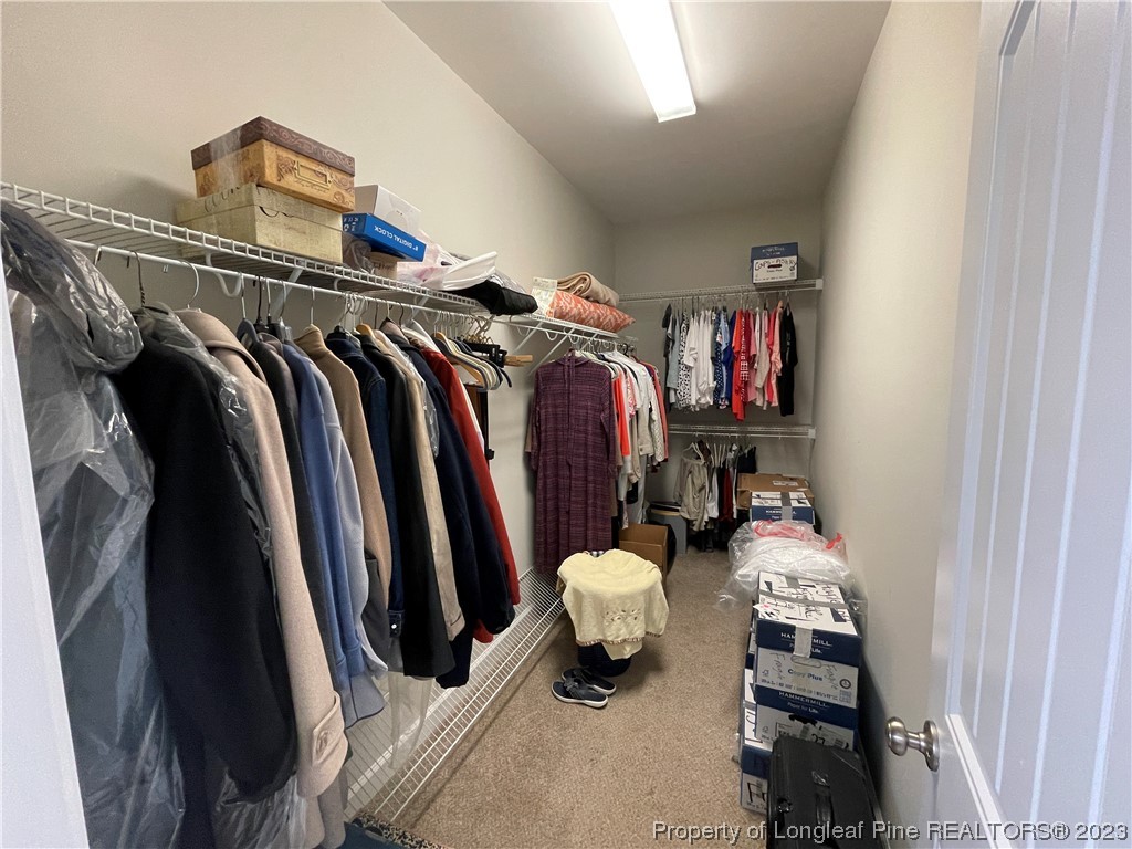 6298 Phillipi Church Road Raeford, NC 28376 - Photo 24 of 31 a view of walk in closet with clothes and shoes