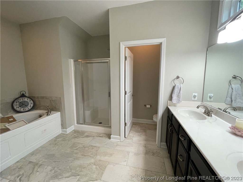 6298 Phillipi Church Road Raeford, NC 28376 - Photo 25 of 31 a bathroom with a sink a toilet and shower