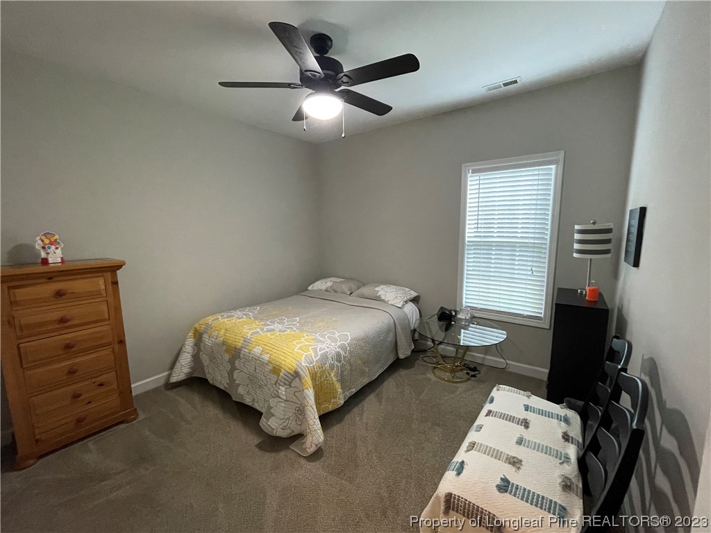 6298 Phillipi Church Road Raeford, NC 28376 - Photo 8 of 31 a bed sitting in a bedroom next to a window