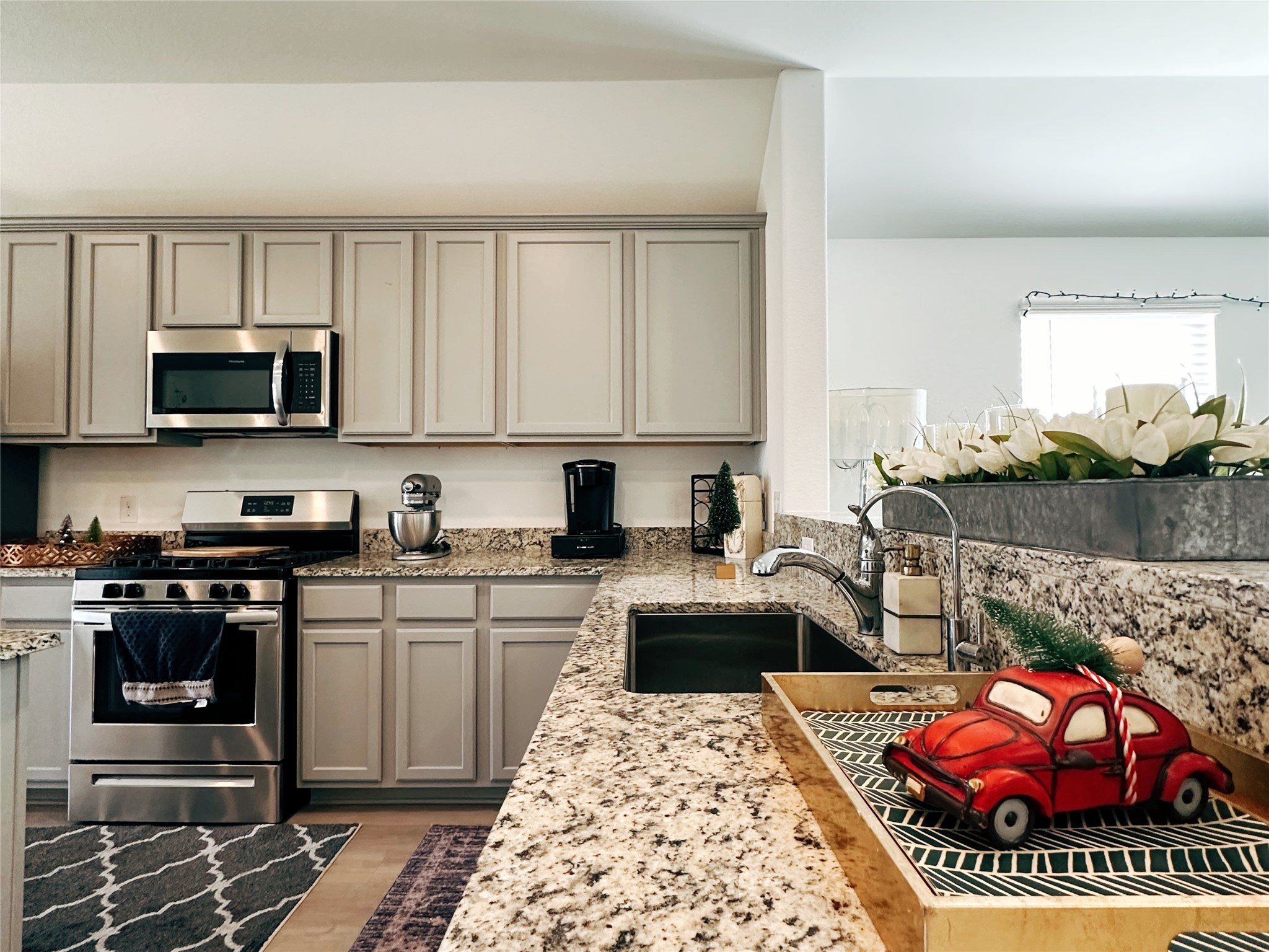 5335 Winding Strm Drive Rosenberg, TX 77469 - Photo 12 of 26 a kitchen with stainless steel appliances granite countertop a stove top oven a sink dishwasher and cabinets with wooden floor