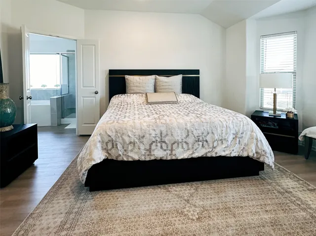 a bedroom with a bed and a couch