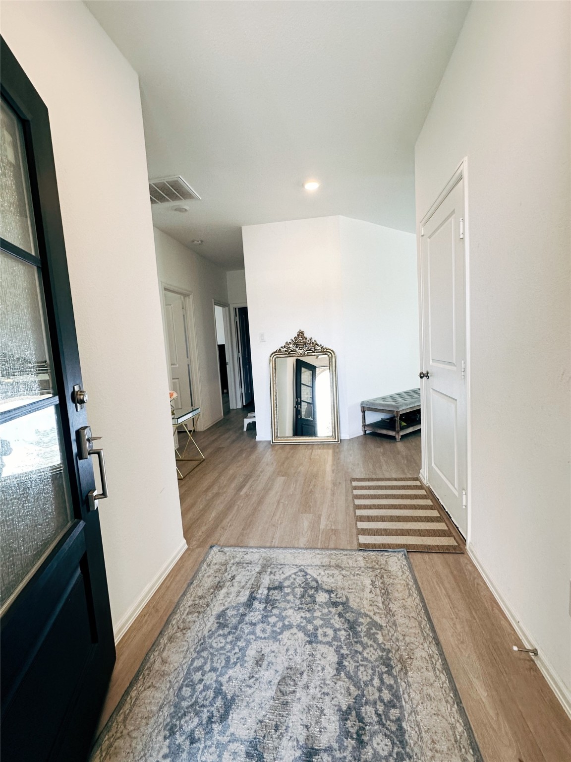 5335 Winding Strm Drive Rosenberg, TX 77469 - Photo 2 of 26 a view of a hallway with wooden floor and staircase