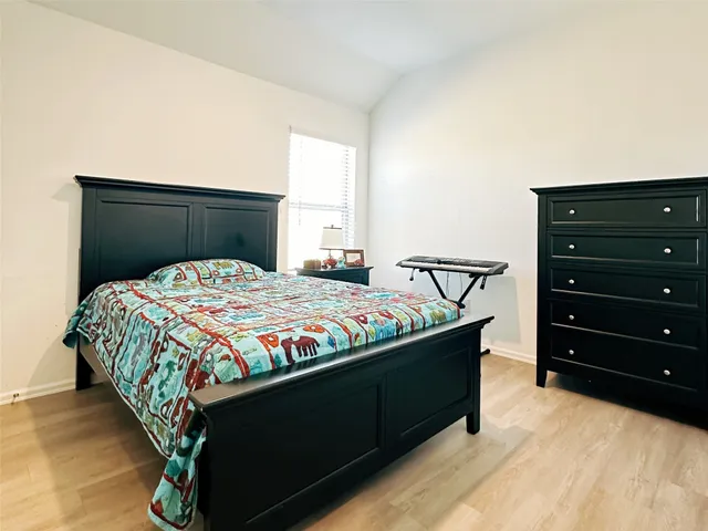 a bedroom with a bed and a dresser