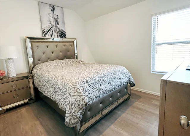 a bedroom with a bed and window