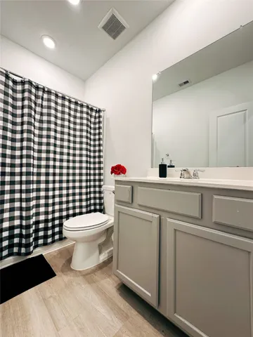 a bathroom with a toilet a sink and a shower