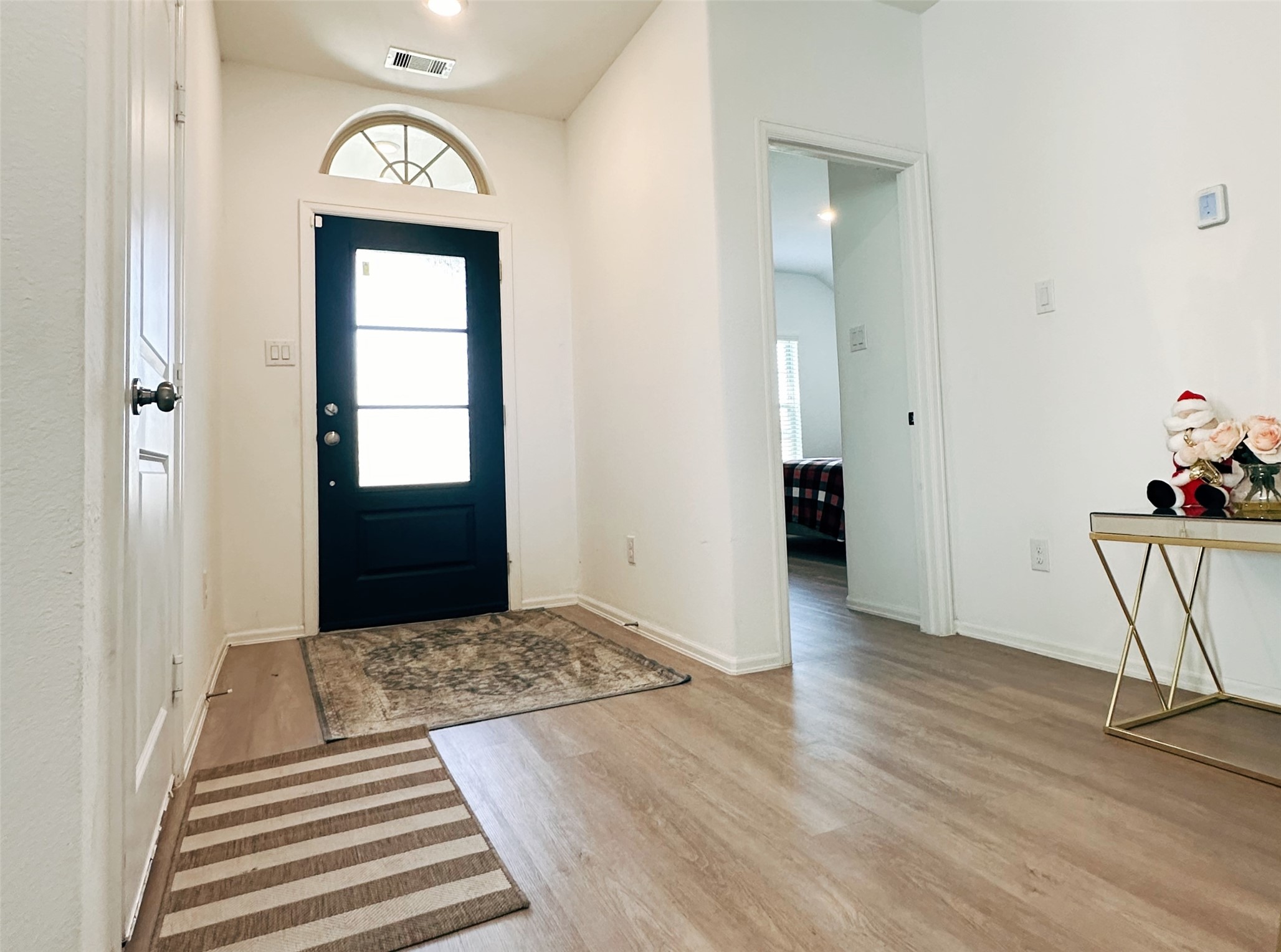 5335 Winding Strm Drive Rosenberg, TX 77469 - Photo 3 of 26 a view of a hallway to a livingroom with wooden floor and a window